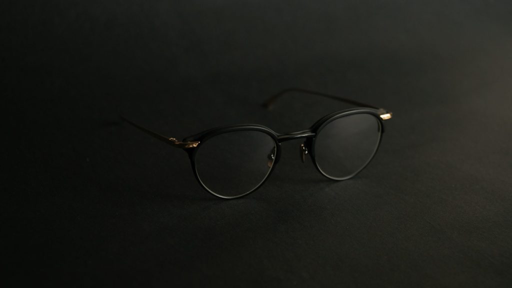silver framed eyeglasses on black surface