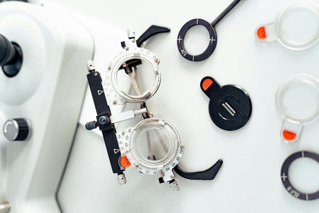 Close-up of optometry trial frame and lenses on white surface.